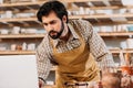 male potter in apron working with laptop Royalty Free Stock Photo