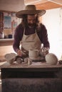 Male potter making pot