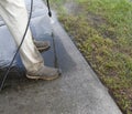 Male Pressure Washing Sidewalk