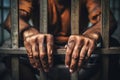 The male prisoner grabbed the prison bars with his hands. The pain and suffering of the prisoner. The inevitability of a judicial Royalty Free Stock Photo