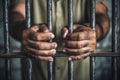 The male prisoner grabbed the prison bars with his hands. The pain and suffering of the prisoner. The inevitability of a judicial Royalty Free Stock Photo