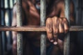 The male prisoner grabbed the prison bars with his hands. The pain and suffering of the prisoner. The inevitability of a judicial Royalty Free Stock Photo