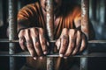 The male prisoner grabbed the prison bars with his hands. The pain and suffering of the prisoner. The inevitability of a judicial Royalty Free Stock Photo