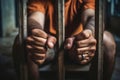 The male prisoner grabbed the prison bars with his hands. The pain and suffering of the prisoner. The inevitability of a judicial Royalty Free Stock Photo