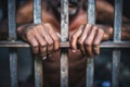 The male prisoner grabbed the prison bars with his hands. The pain and suffering of the prisoner. The inevitability of a judicial Royalty Free Stock Photo