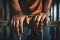 The male prisoner grabbed the prison bars with his hands. The pain and suffering of the prisoner. The inevitability of a judicial Royalty Free Stock Photo