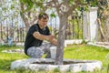 Male processes whitewash trunks of fruit trees at summer cottage