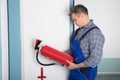 Professional Checking A Fire Extinguisher Royalty Free Stock Photo