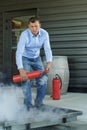 male professional checking fire extinguisher Royalty Free Stock Photo