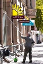 Male professional cleaning service worker cleans the shop windows