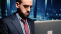Male professional server IT engineer using laptop in data center