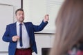 Male professor explain lesson to students and interact with them in the classroom.Helping a students during class. University Royalty Free Stock Photo