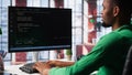 Male programmer types code on computer and running script Royalty Free Stock Photo