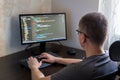 Male programmer working on computer with coding interface and modern workspace design Royalty Free Stock Photo