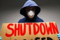 Male protester holding placard against coronavirus lockdowns against grey background Royalty Free Stock Photo