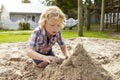 Male Pupil At Montessori School Playing In Sand Pit At Breaktime Royalty Free Stock Photo