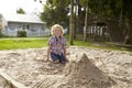 Male Pupil At Montessori School Playing In Sand Pit At Breaktime Royalty Free Stock Photo