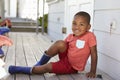 Male Pupil At Montessori School Putting On Wellington Boots Royalty Free Stock Photo