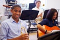 Male Pupil Playing Trumpet In High School Orchestra Royalty Free Stock Photo