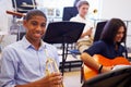 Male Pupil Playing Trumpet In High School Orchestra