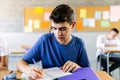 Male pupil student studying at desk in school classroom Royalty Free Stock Photo