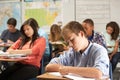 Male Pupil Studying At Desk In Classroom Royalty Free Stock Photo