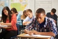 Male Pupil Studying At Desk In Classroom Royalty Free Stock Photo