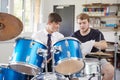 Male Pupil With Teacher Playing Drums In Music Lesson Royalty Free Stock Photo