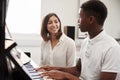 Male Pupil With Teacher Playing Piano In Music Lesson Royalty Free Stock Photo