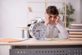 Male pupil in time management concept Royalty Free Stock Photo