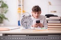 Male pupil in time management concept Royalty Free Stock Photo