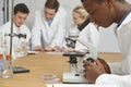 Male Pupil Using Microscope In Science Class Royalty Free Stock Photo