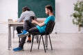 Two male pupils in bullying concept in the classroom