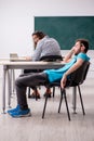 Two male pupils in bullying concept in the classroom