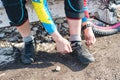 Male racer mtb cyclist preparing for race tying shoelaces