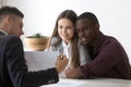 Male realtor showing house plan to young family buyers Royalty Free Stock Photo