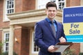 Portrait Of Male Realtor Standing Outside Residential Property W Royalty Free Stock Photo