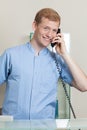 Male receptionist talking on phone