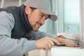 male repairman fixing window with screwdriver Royalty Free Stock Photo