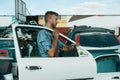 Male repairman holds door on car junkyard Royalty Free Stock Photo