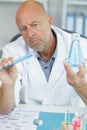 Male researcher holding flask with blue liquid in lab Royalty Free Stock Photo