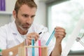 male researcher holding test tube