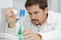 male researcher holding test tube