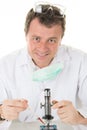 Male researcher microscope carrying out scientific research