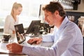 Male restaurant manager working on laptop Royalty Free Stock Photo