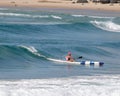 Male riding a kayak in the ocean on the Gold Coast