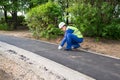 Male road repairman doing the final work on the street