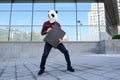 Male robber wearing a panda head mask stealing a briefcase escaping and looking back