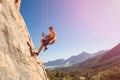 Male rock climber on belay rope