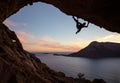 Male rock climber climbing along a roof in a cave Royalty Free Stock Photo